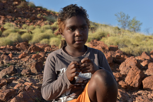 Young Boy Sitting on the Rocky Mountain