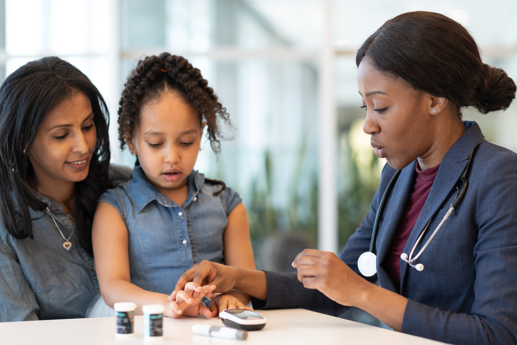Diabetic child at doctor's appointment with her mother